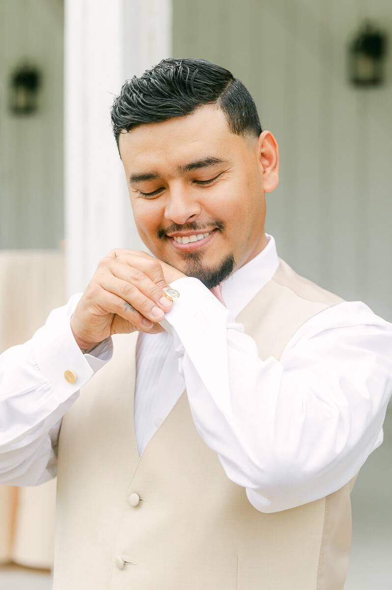 groom getting ready at the farmhouse wedding venue