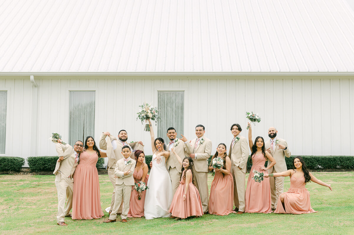 wedding party in front of the farmhouse