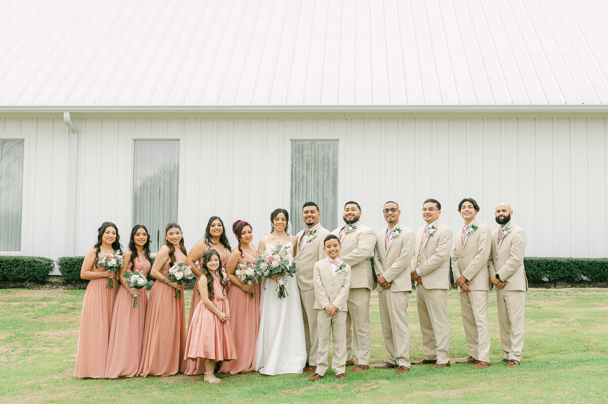 wedding party in front of the farmhouse