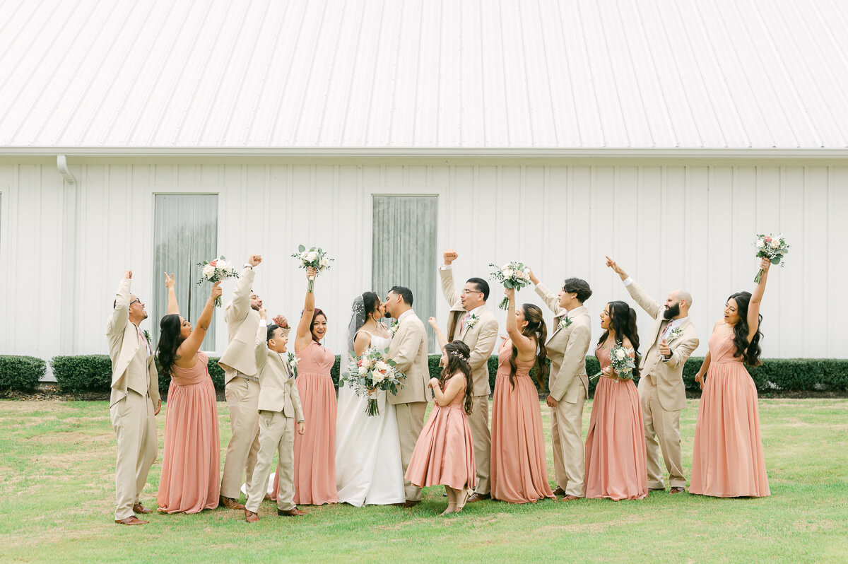 wedding party in front of the farmhouse