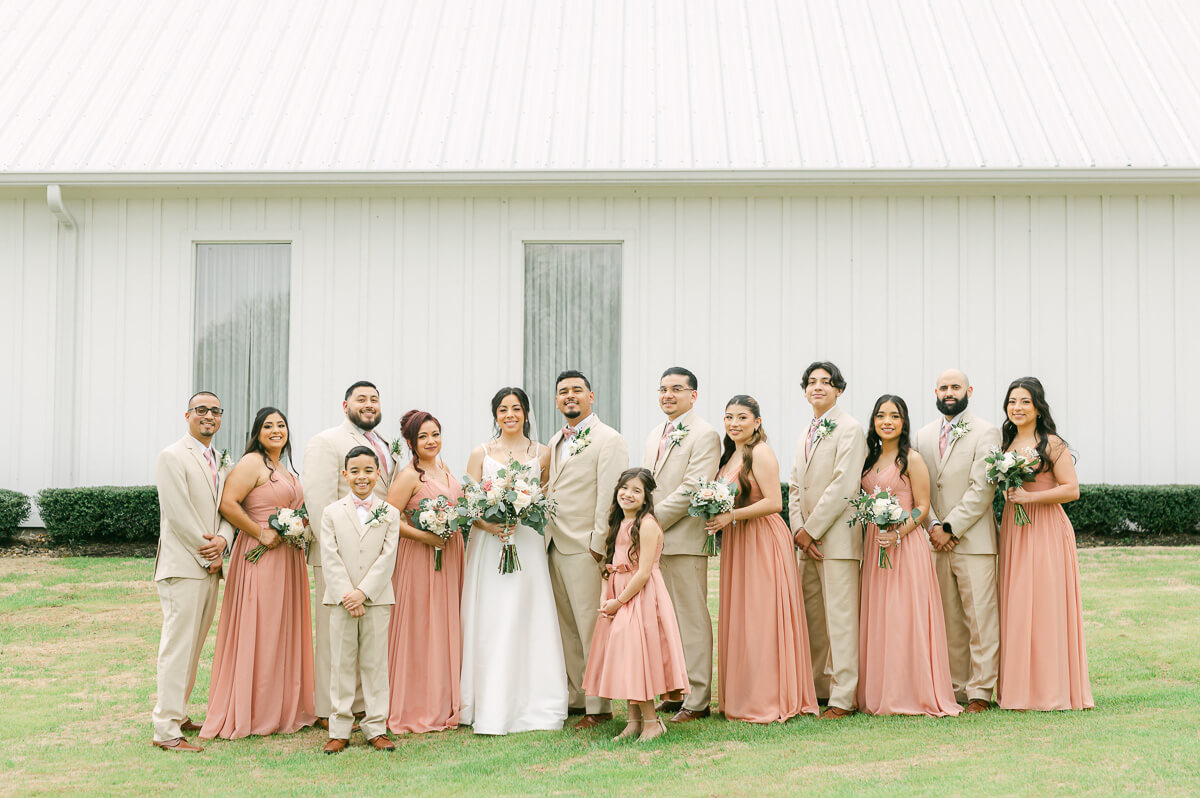 wedding party in front of the farmhouse