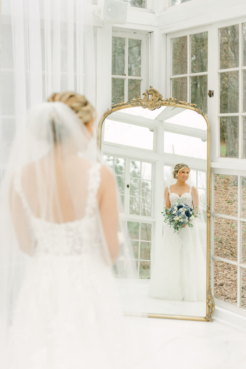 bride posing in mirror during bridal session photographed by Conroe wedding photographer 