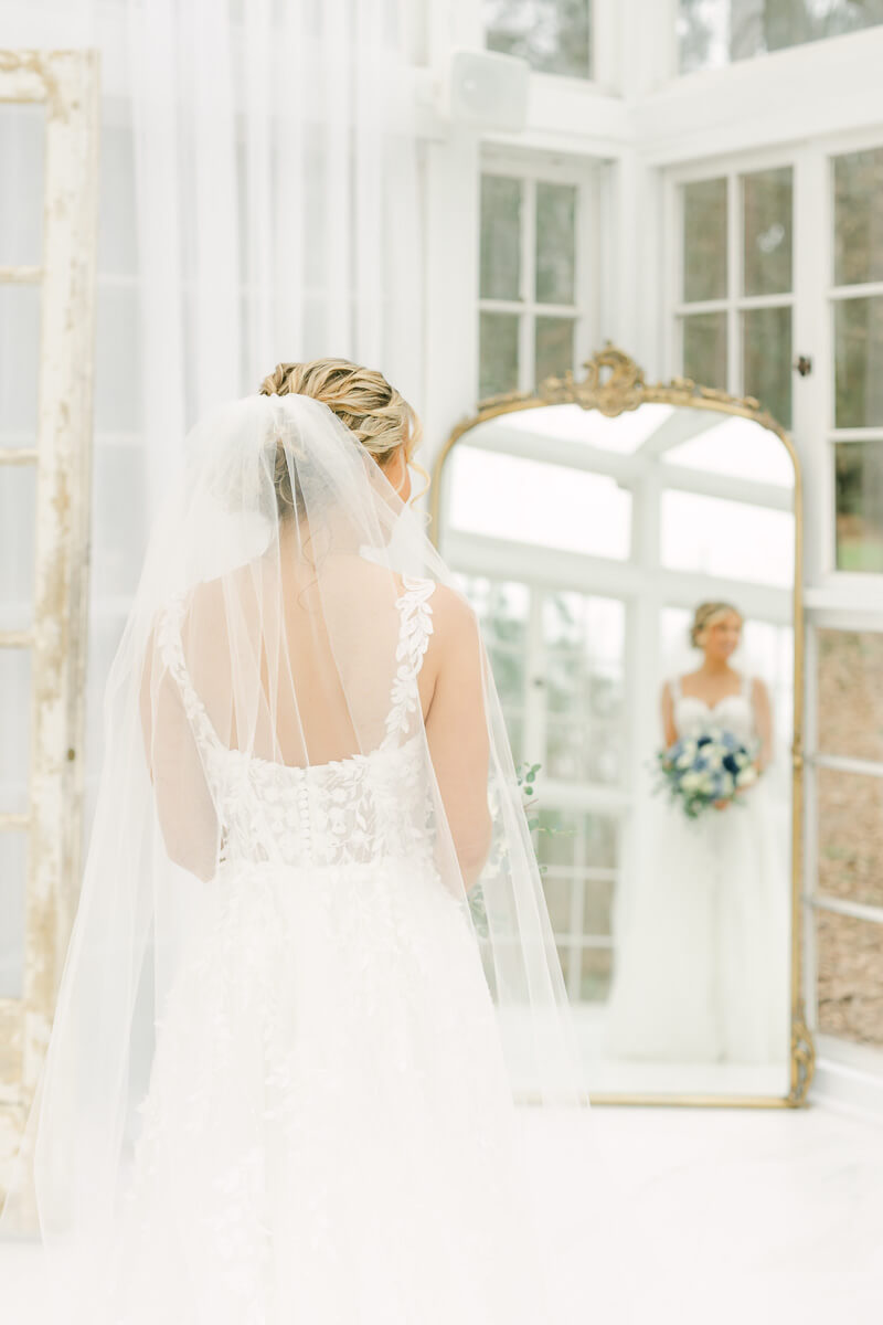 bride posing in mirror during bridal session photographed by Conroe wedding photographer 