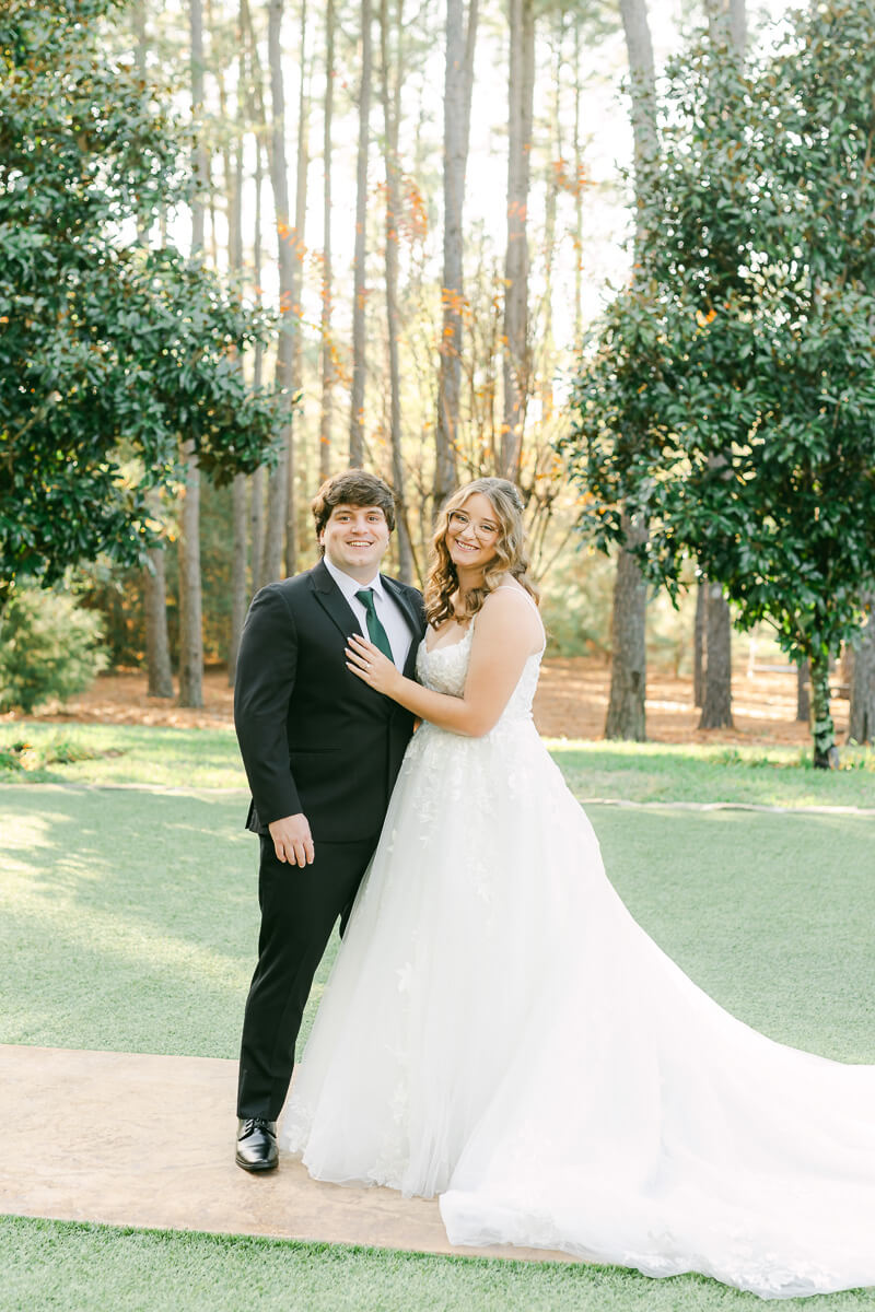 bride and groom posing for magnolia, tx wedding photographer