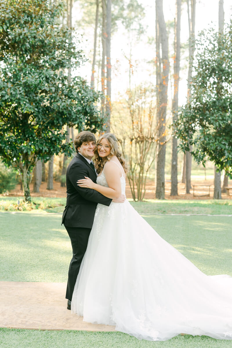 bride and groom posing for magnolia, tx wedding photographer