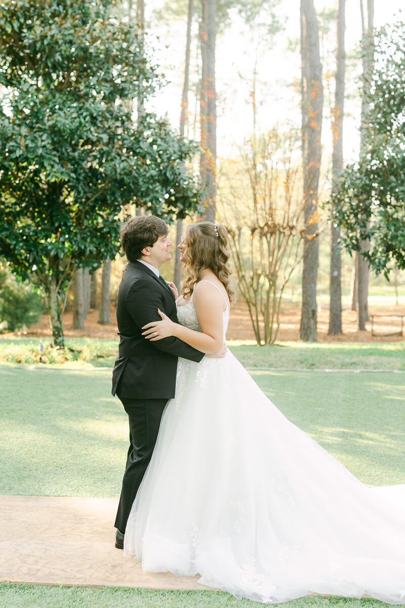 bride and groom posing for magnolia, tx wedding photographer