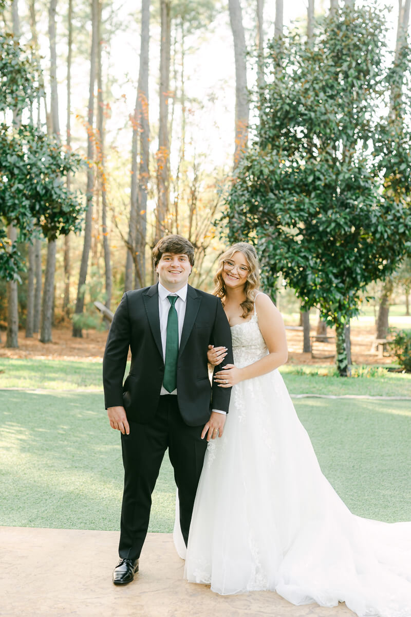 bride and groom posing for magnolia, tx wedding photographer