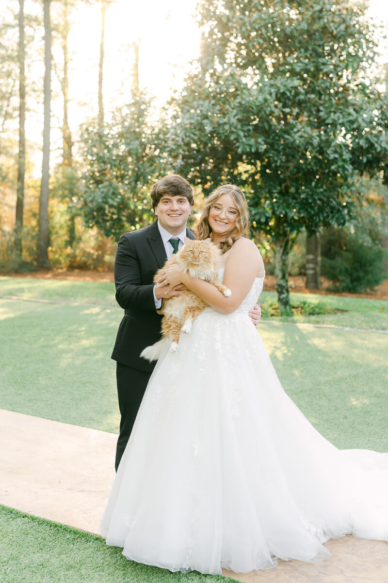 a couple posing with their cat