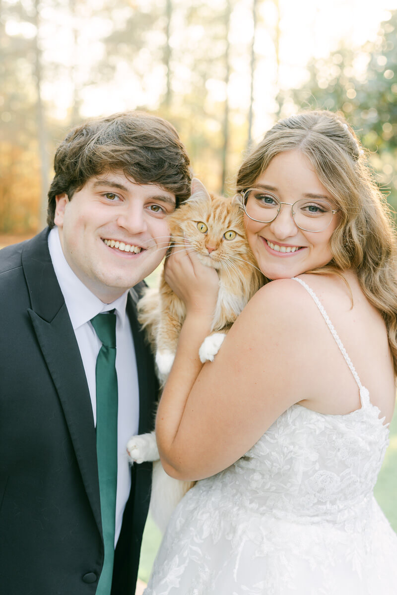 a couple posing with their cat