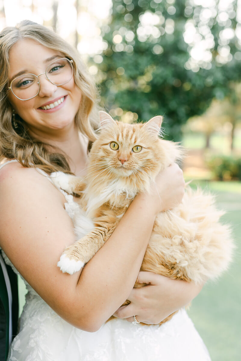 a bride posing with a cat