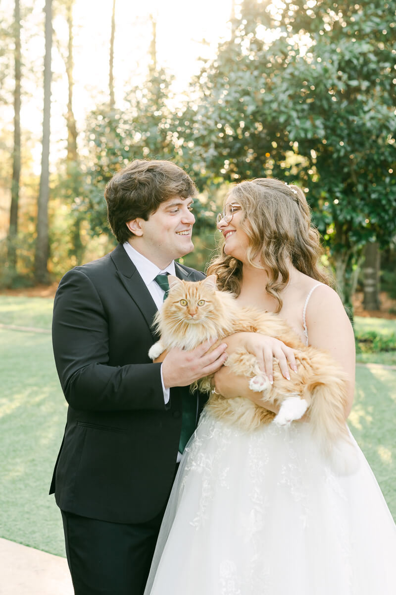 a couple posing with their cat