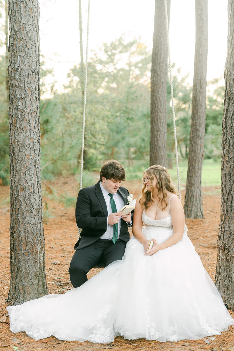 couple reading their wedding vows on a swing in Magnolia, Tx