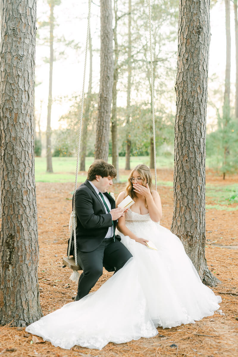 couple reading their wedding vows on a swing in Magnolia, Tx