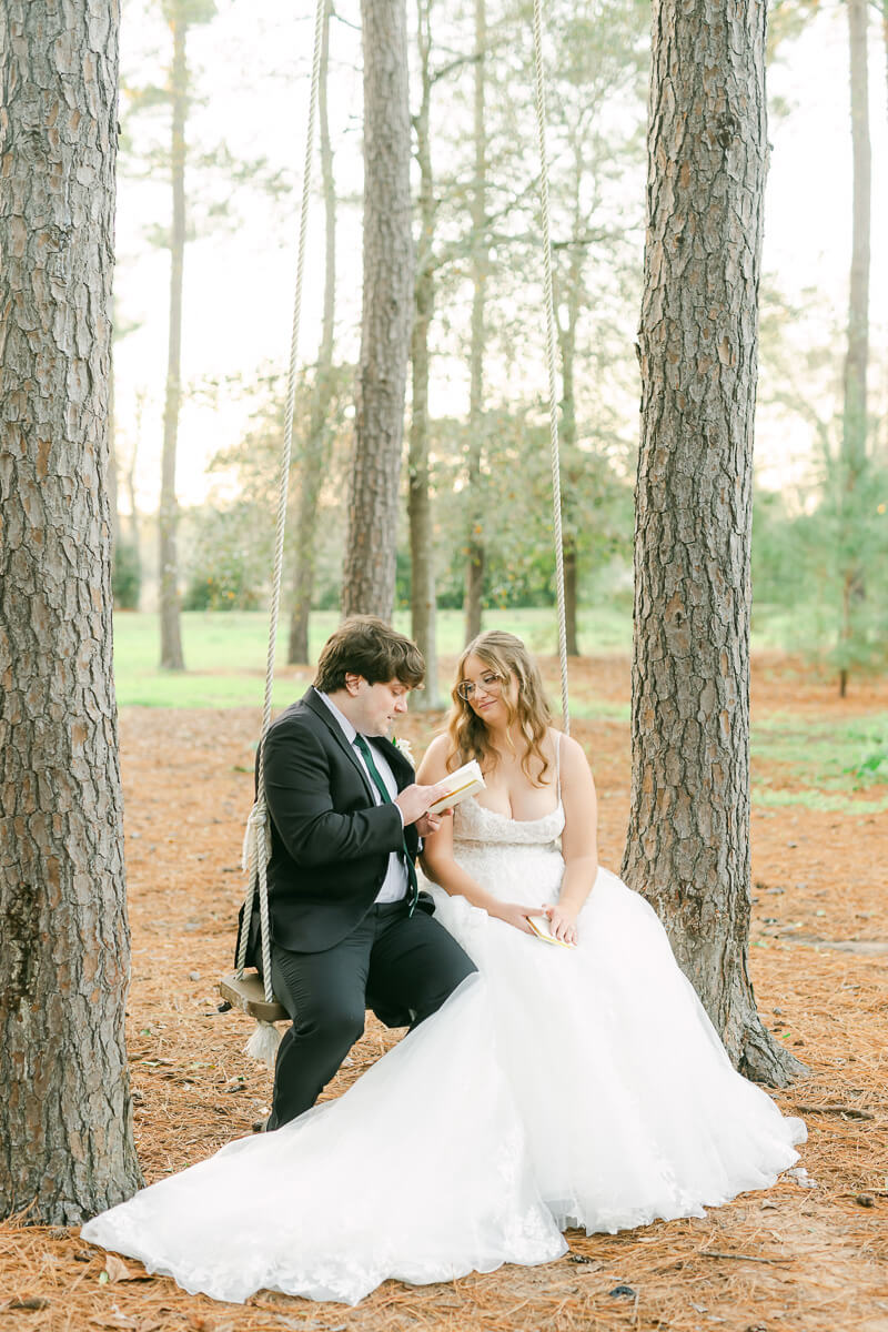 couple reading their wedding vows on a swing in Magnolia, Tx