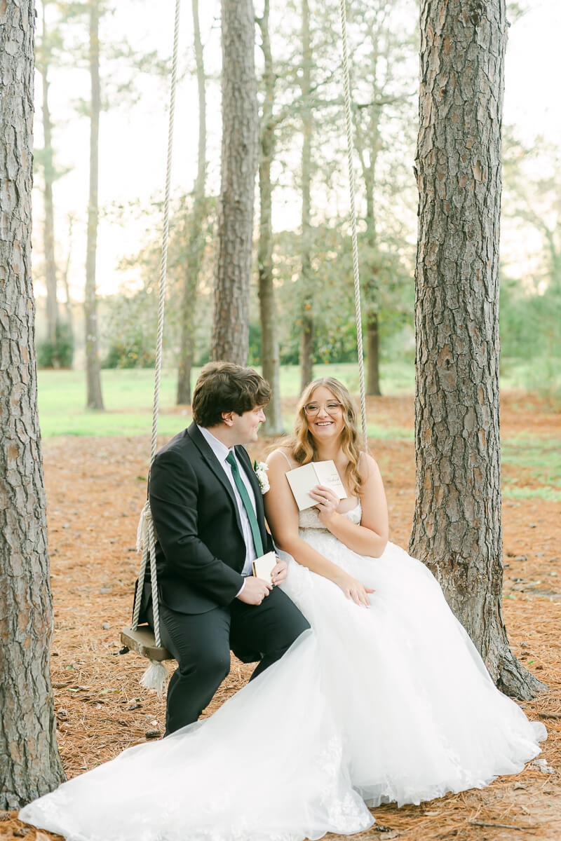 couple reading their wedding vows on a swing in Magnolia, Tx