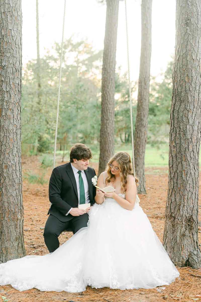 couple reading their wedding vows on a swing in Magnolia, Tx