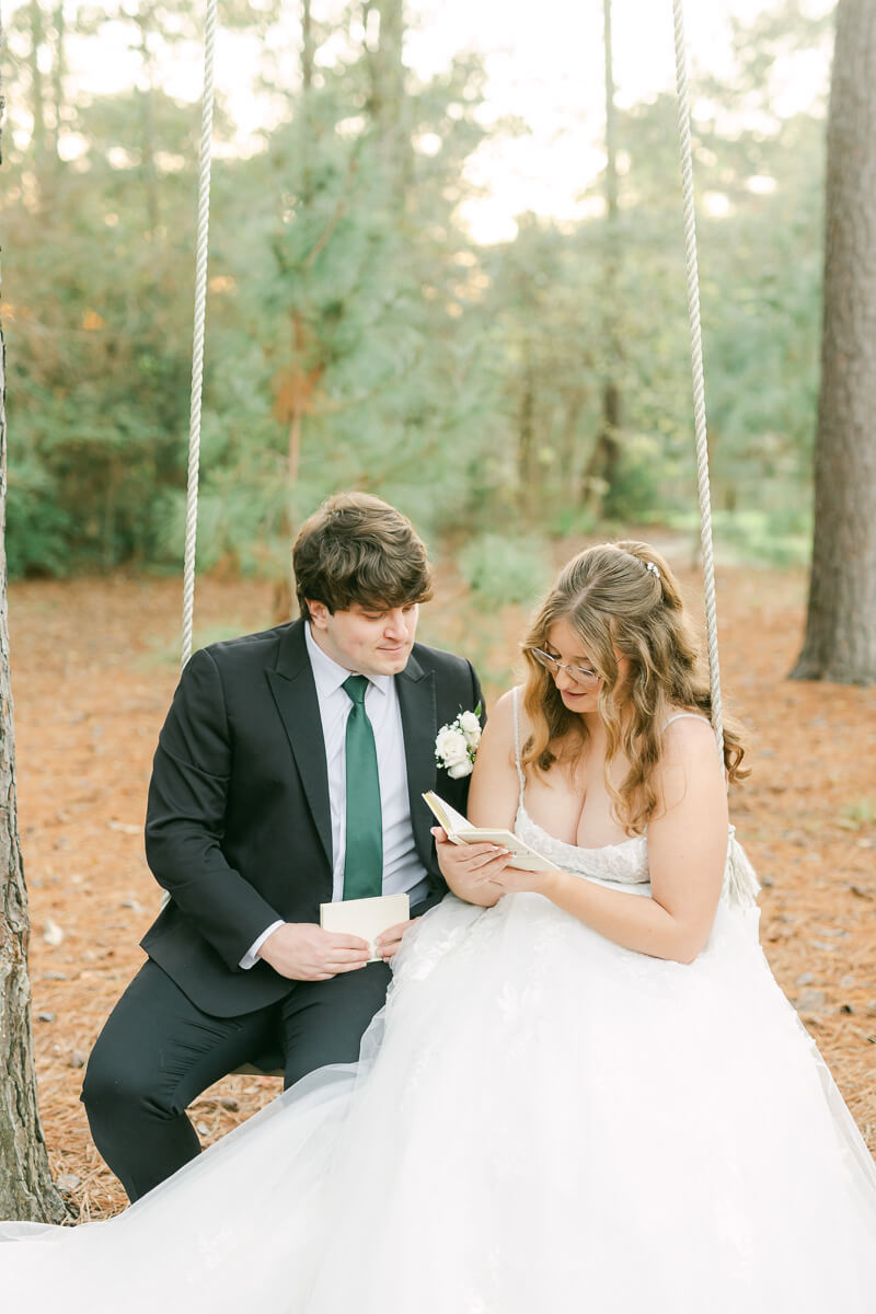 couple reading their wedding vows on a swing in Magnolia, Tx