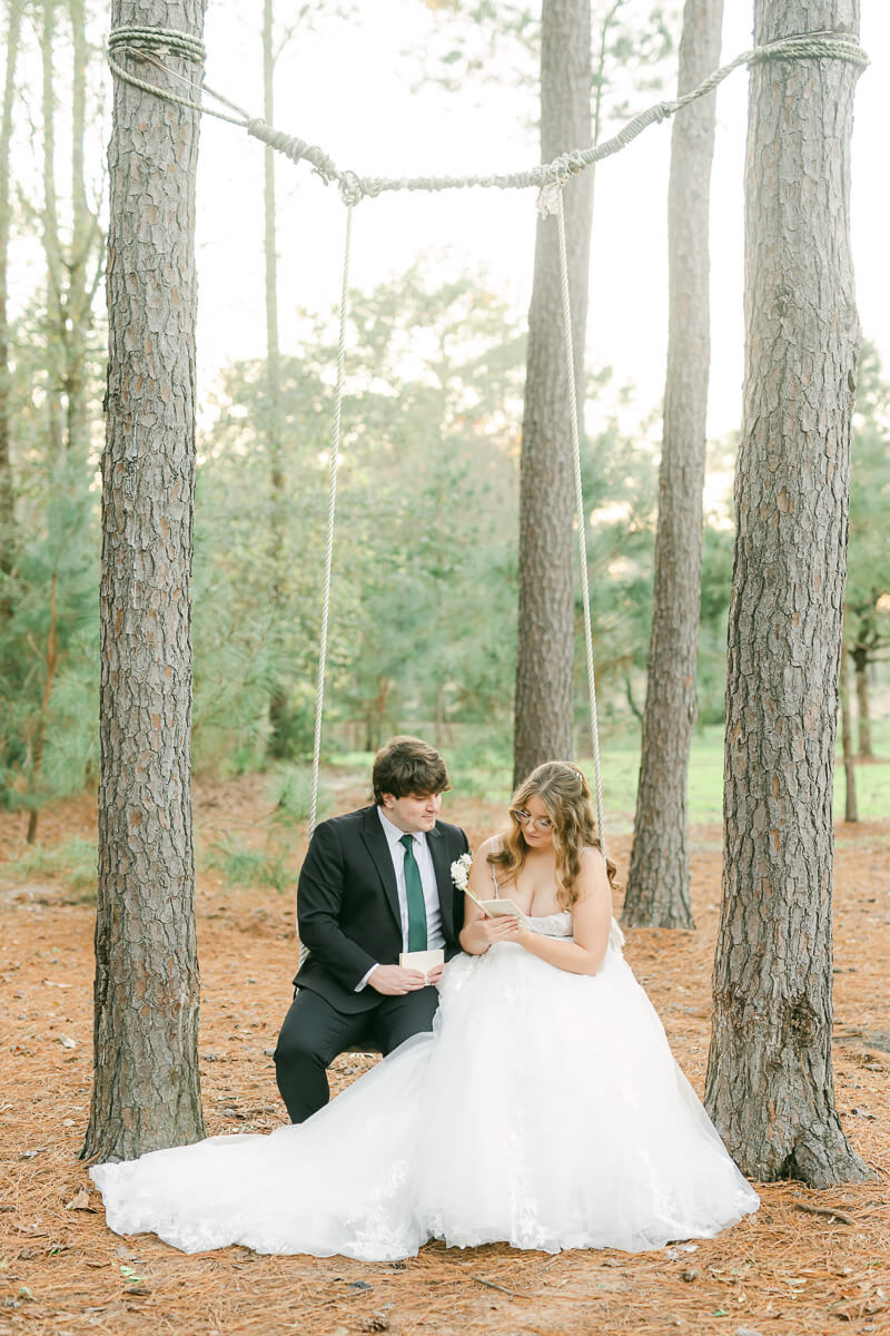 couple reading their wedding vows on a swing in Magnolia, Tx