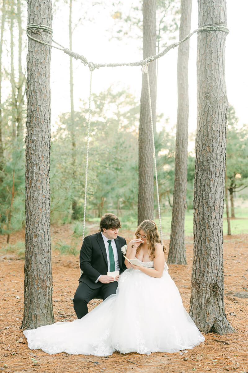 couple reading their wedding vows on a swing in Magnolia, Tx