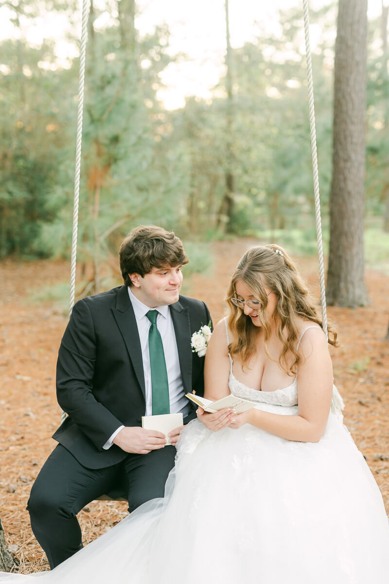 couple reading their wedding vows on a swing in Magnolia, Tx