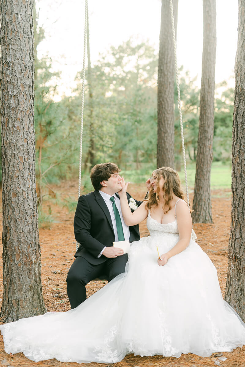 couple reading their wedding vows on a swing in Magnolia, Tx