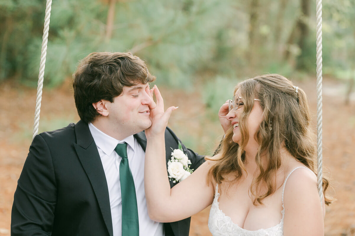 couple reading their wedding vows on a swing in Magnolia, Tx