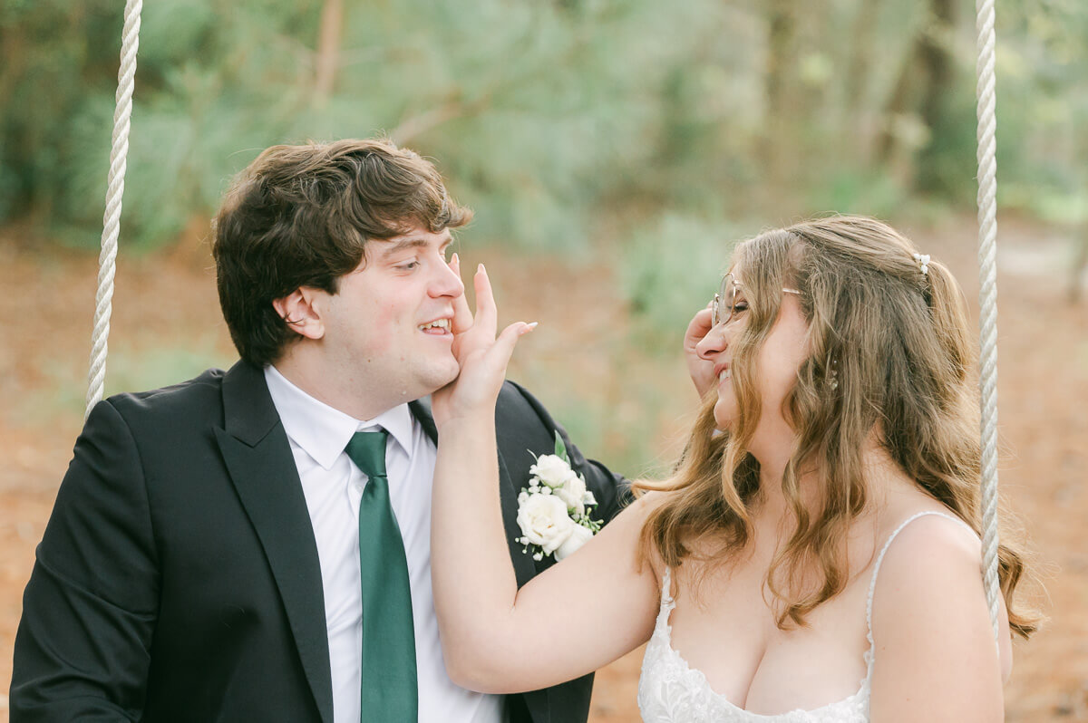 couple reading their wedding vows on a swing in Magnolia, Tx