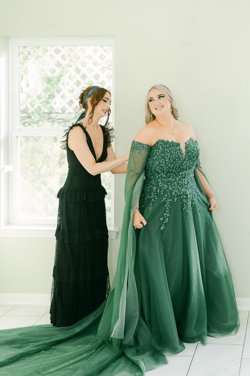 bride getting ready in emerald green wedding dress at Olive Branch House 