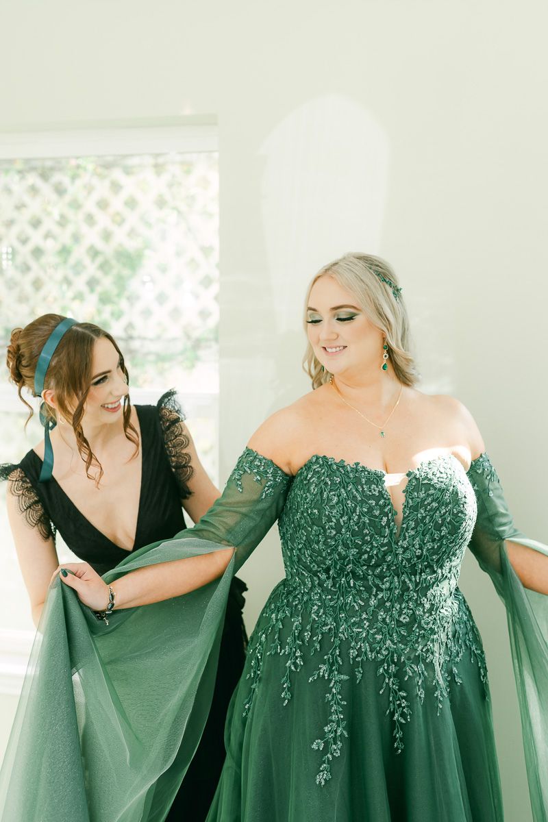 bride getting ready in emerald green wedding dress at Olive Branch House 