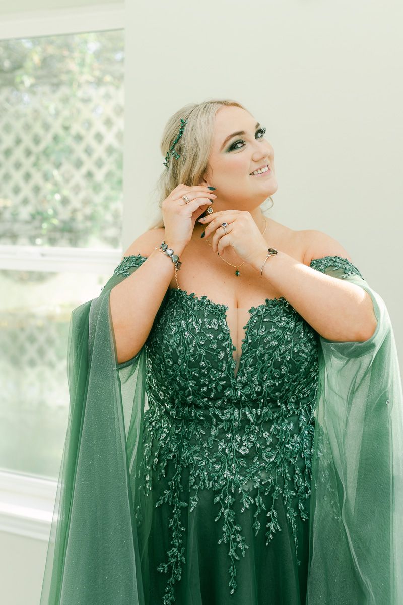 bride getting ready in emerald green wedding dress at Olive Branch House 