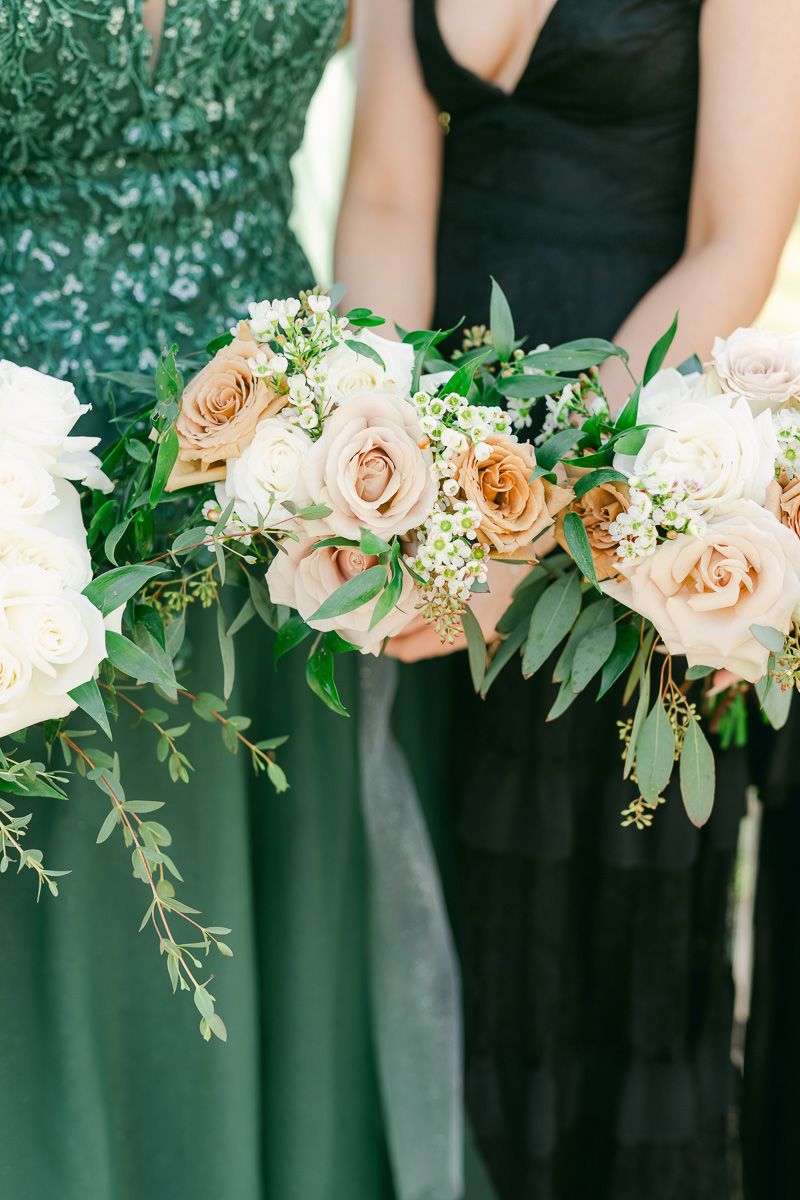 wedding party wearing black and holding bouquets