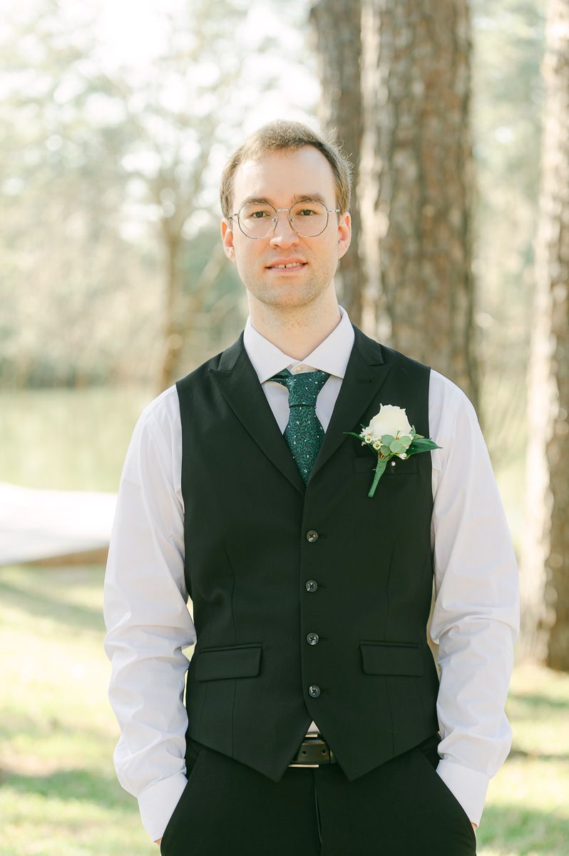 groom wearing black with green tie at Forever 5 Events