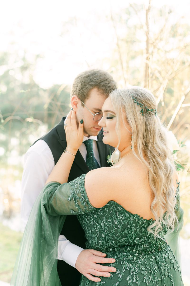 groom with bride wearing emerald green wedding dress