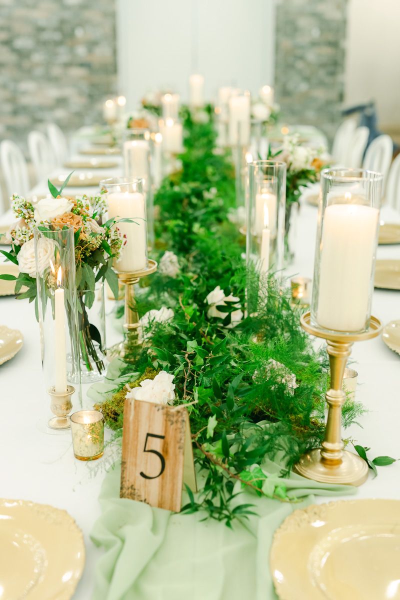 wedding reception details featuring moss and candles