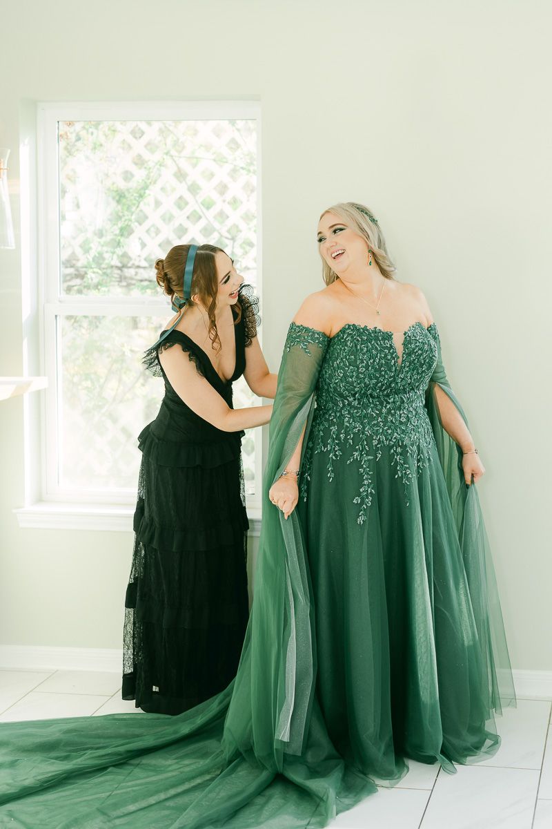 bride getting ready in emerald green wedding dress at Olive Branch House 