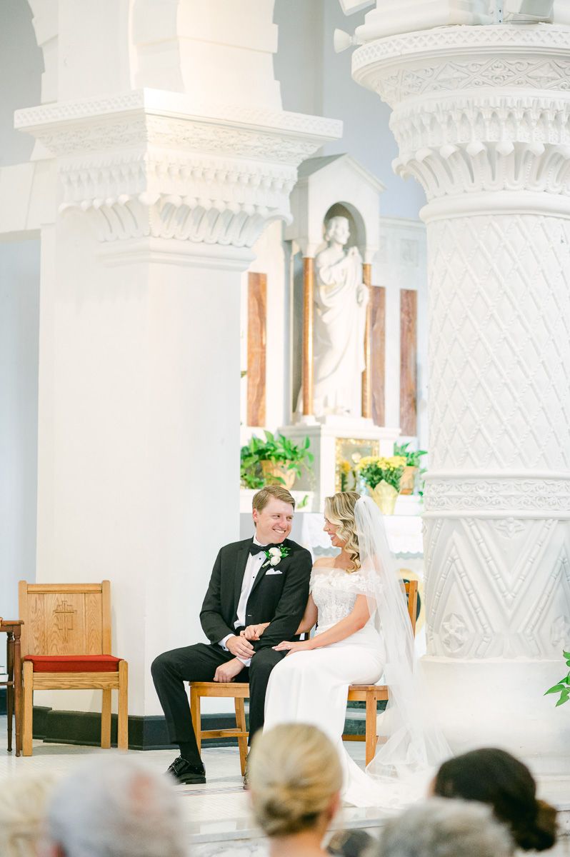 bride and groom during their ceremony at Sacred Heart Catholic Church
