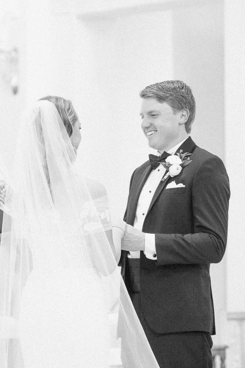 bride and groom during their ceremony at Sacred Heart Catholic Church