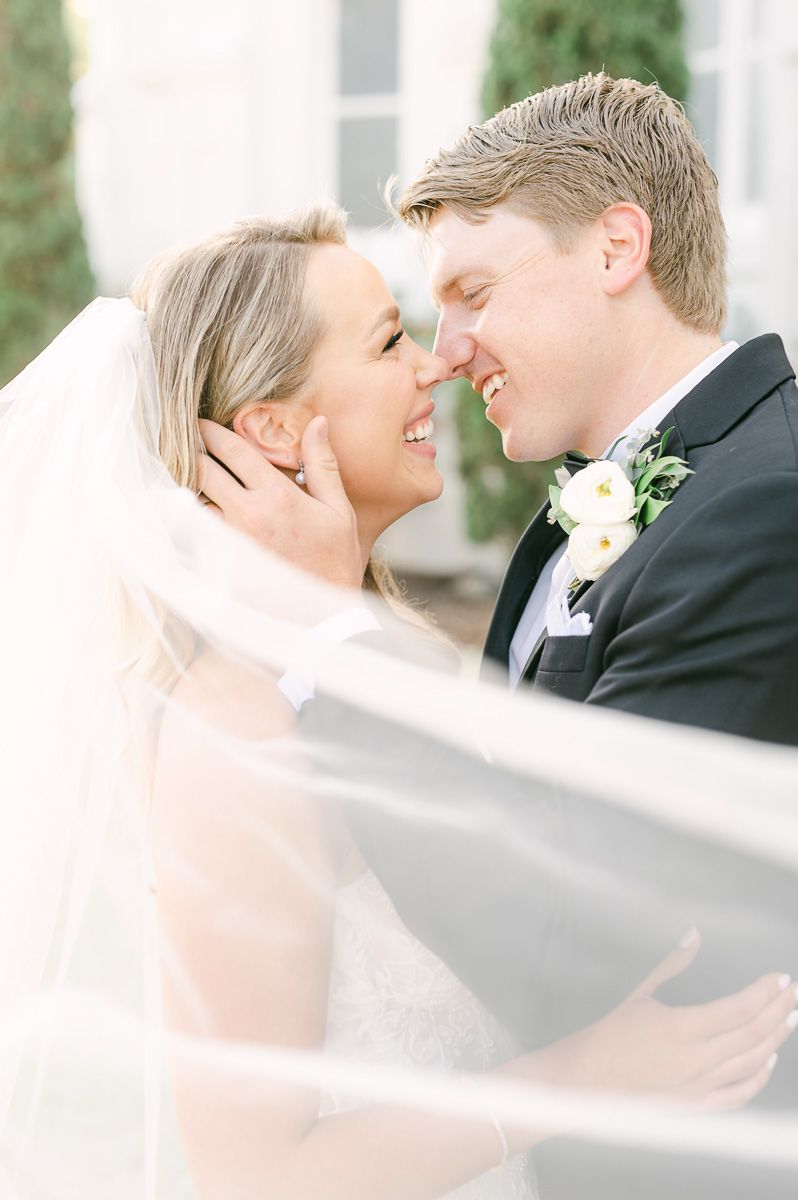 bride and groom with veil flowing