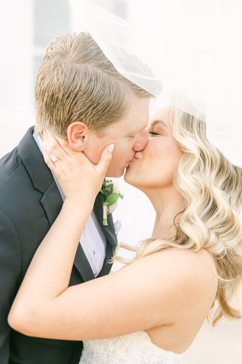 bride and groom under the veil in Galveston