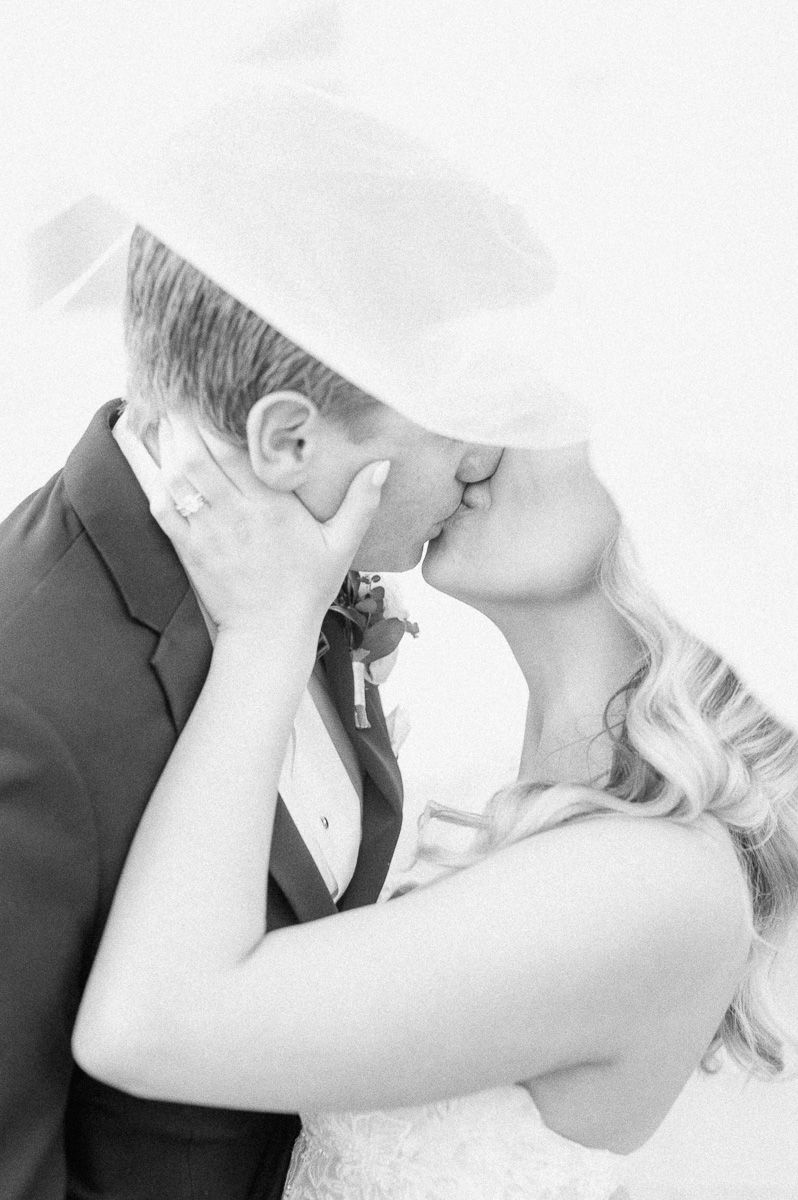 bride and groom under the veil in Galveston