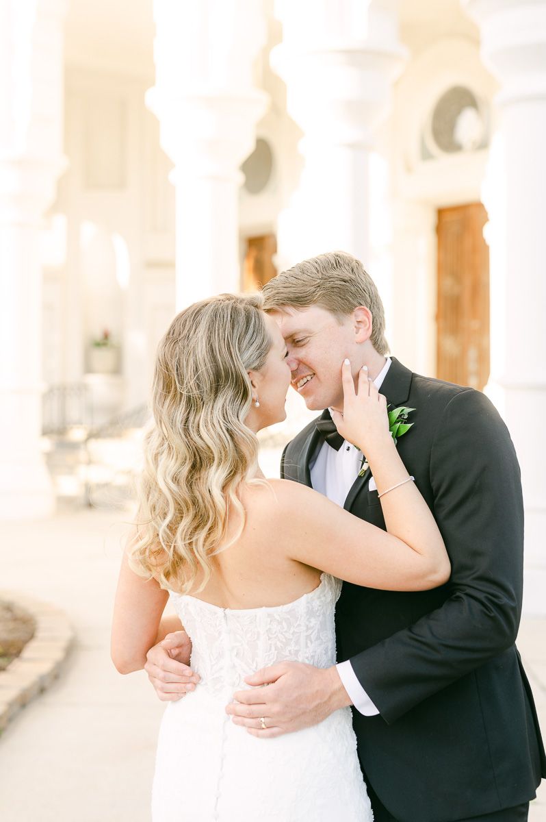 bride and groom cuddling outside Galveston wedding venue