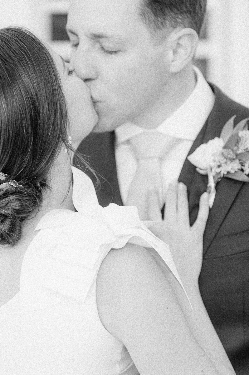 black and white photo of couple kissing