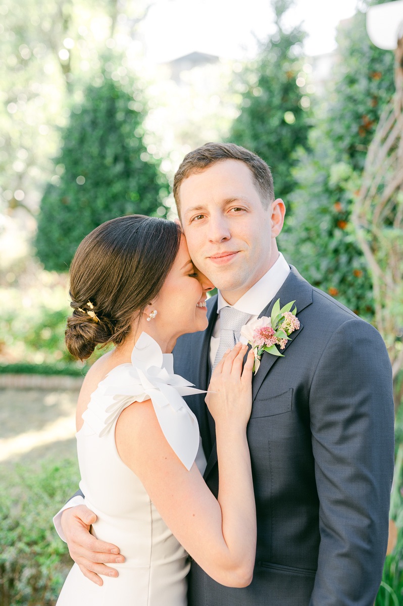 bride cuddling her groom before wedding ceremony