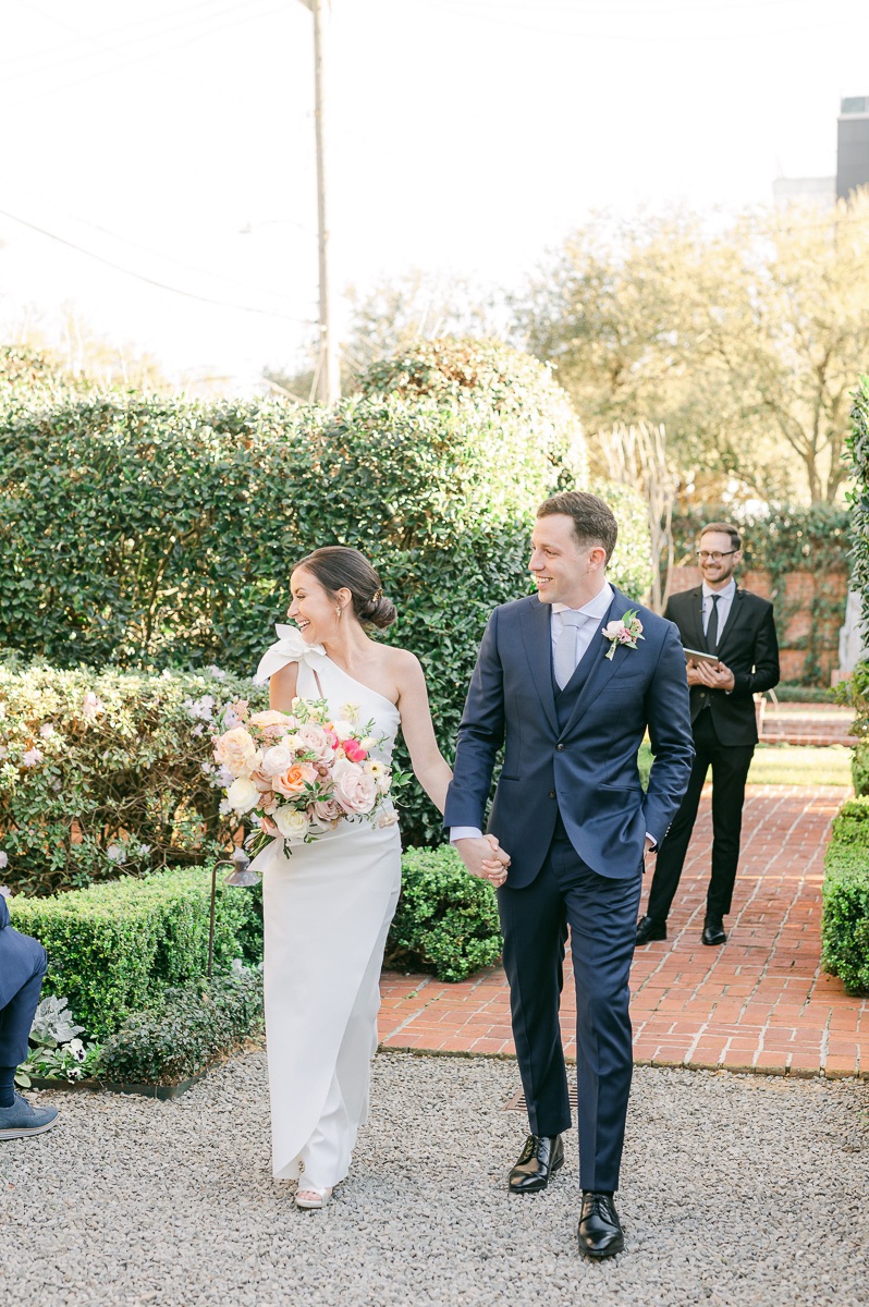 couple walking up the aisle at houston garden wedding