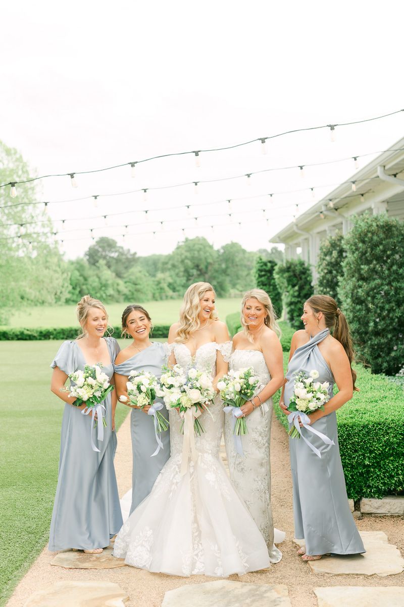 bridesmaids in blue dresses outside The Farmhouse