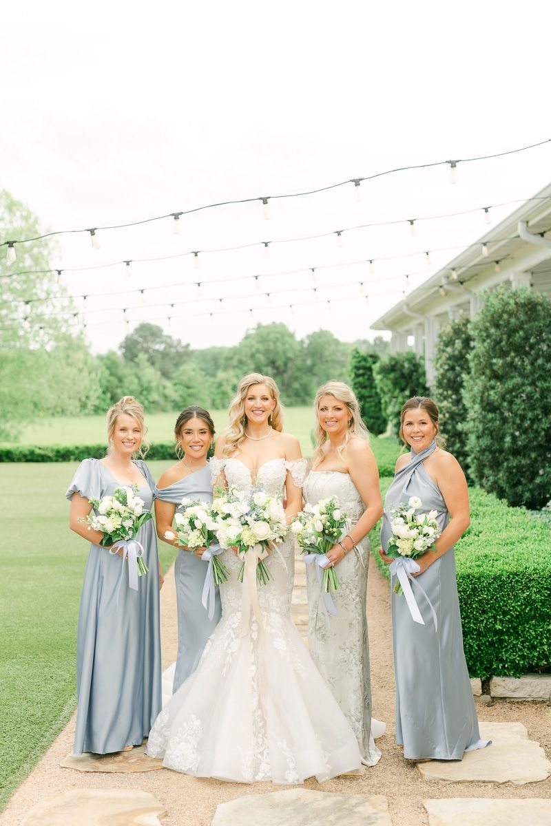 bridesmaids in blue dresses outside The Farmhouse
