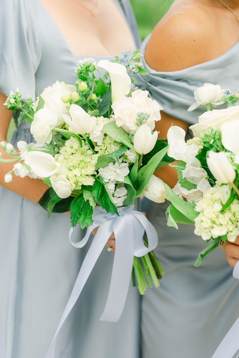 bridesmaids bouquets with white flowers and blue accents
