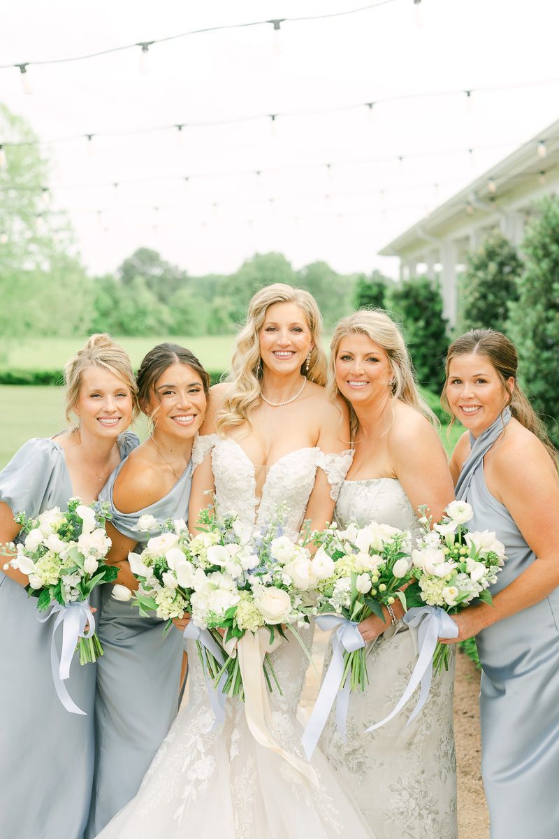 bridesmaids in blue dresses outside The Farmhouse