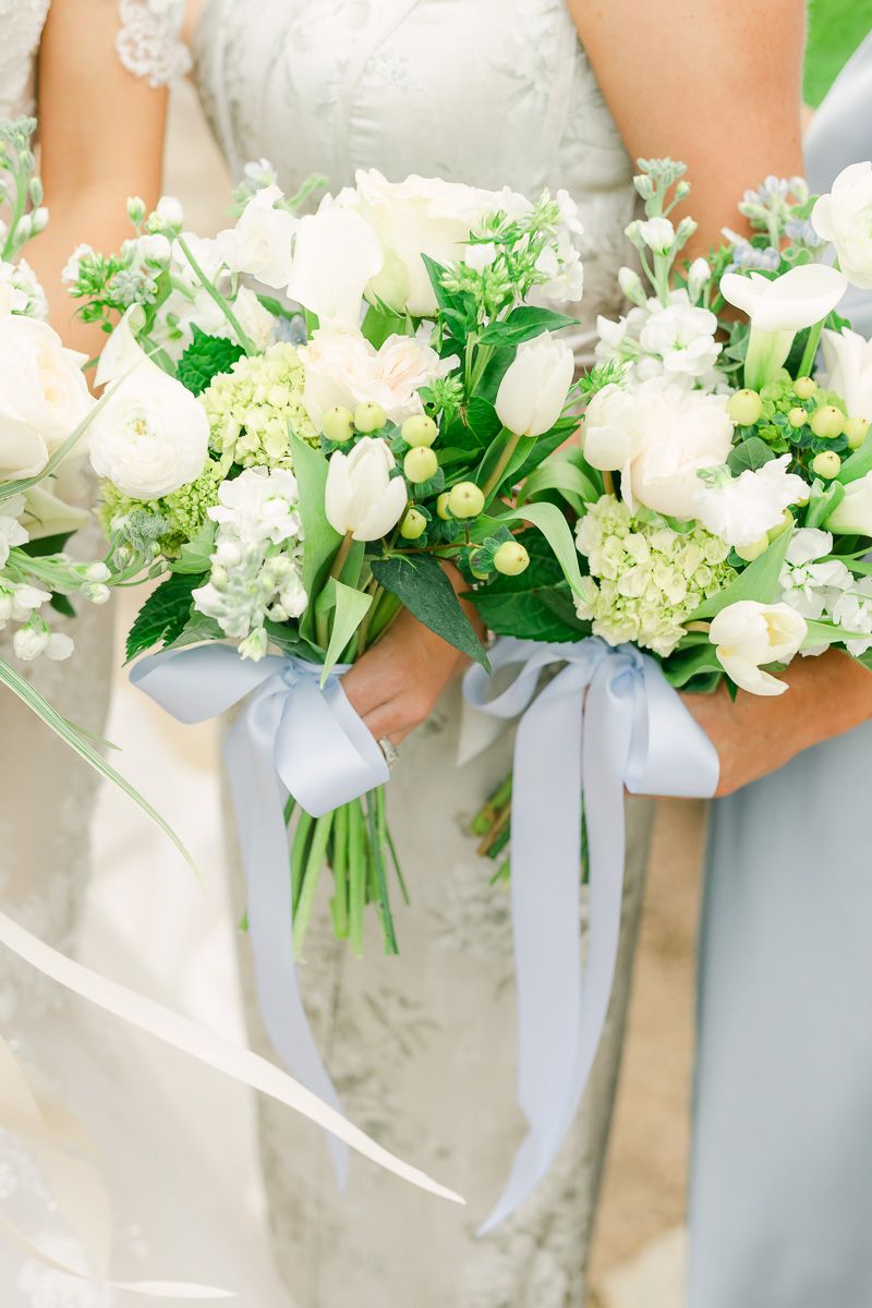 bridesmaids bouquets with white flowers and blue accents