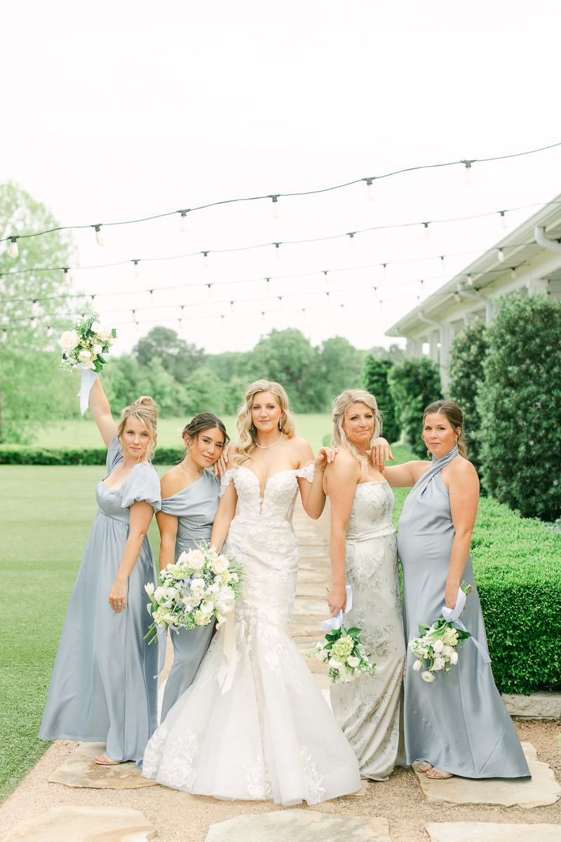 bridesmaids in blue dresses outside The Farmhouse